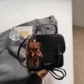 Detail of black faux leather backpack with vintage buckles and a plush bear keychain charm - With Pendant / Black