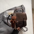 Detail view of vintage dark brown faux leather handbag with cute plush bear charm - With Pendant / Brown