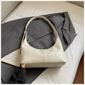 White woven leather half-moon shoulder bag on a grey blazer for office commute - White (Without Charm)