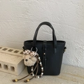 Minimalist black pebble grain bucket bag with handles and a decorative bear charm - Black with Pendant
