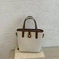 Chic beige bucket bag with brown handles and lychee grain texture on a stone base - White Without Pendant