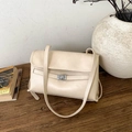 Detailed view of beige vintage crossbody bag with silver clasp on a wooden desk - No Pendant / Off White