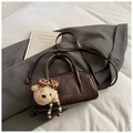 Dark brown glossy bowling bag featuring a cute plush bear charm and crossbody strap - With Charm Style / Coffee with Pendant