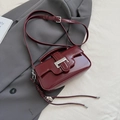 Burgundy glossy faux leather crossbody bag with silver metal buckle and top handle - Red with Pendant