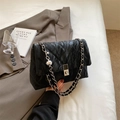 Fashionable black quilted shoulder bag with silver chain strap and stylish twist lock - Black
