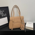 Detail of khaki pebbled leather tote bag with elegant flap and plush bear charm - With Charm / Khaki