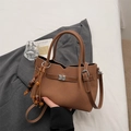 Caramel brown textured leather handbag with bohemian beaded charm and double top handles - Brown with Pendant