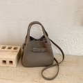 Minimalist taupe lychee leather bucket bag with top handles and shoulder strap - Grey Without Pendant