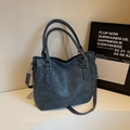 Detail of soft leather tote bag with lychee texture and silver hardware in dark blue - Lake Blue