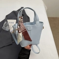Detail of light blue bucket bag with houndstooth silk scarf and fashion closure - Blue