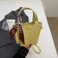 Detail of yellow leather bucket bag with houndstooth scarf handle and side strap - Yellow