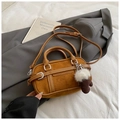 Detail of a brown suede Boston bag with leather trim and a cute mushroom plush pendant - Brown with Pendant