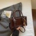 Detail of dark brown leather handbag with contrast stitching and vintage wooden bead charm - Suede Splicing Style (With Charm) / Coffee Suede Splicing With Charm