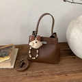 Détail d'un sac à main en cuir marron foncé avec fermoir argenté et breloque ours peluche - Café (Avec Pendentif)