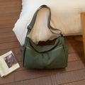 Detail of dark green waterproof nylon crossbody bag with dual front zipper pockets - Green