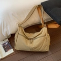 Detail of light khaki nylon tote bag featuring dual front zippers and wide strap - Khaki