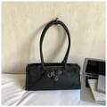 Detail of black minimalist underarm bag with adjustable straps and metal buckles - Black