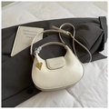 Minimalist creamy white half-moon shoulder bag with a gold heart charm and thin strap - Off White