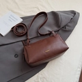 Deep brown vintage pillow bag in textured leather with gold logo and adjustable strap - Brown