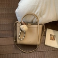 Detail of khaki litchi leather bucket bag with bear charm and beaded accessories - With Charm / Khaki