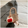 Detailed shot of pink polka dot shell bag with silver chain and cherry charm accessory - Small / Pink