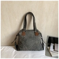 Vintage dark gray tote bag with rivet details and brown leather handles in office setting - Black