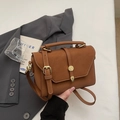 Vintage brown leather crossbody handbag with gold buckle and white stitching details - Brown