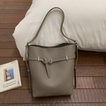 Detail of taupe lychee leather bucket bag with silver buckle and shoulder strap - Gray