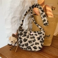 Plush leopard print shoulder bag featuring cute bear charm and soft fuzzy texture - Leopard Print With Charm