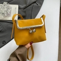 Mini yellow lychee leather crossbody bag with silver frame and spherical clasp - Yellow
