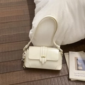 Detail of beige faux leather shoulder bag with gold buckle and white flower charm - White with Pendant