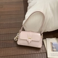 Detail of light pink patent leather shoulder bag with gold buckle and plush charm - Pink with Pendant
