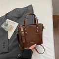 Brown glossy leather bucket bag with gold hardware and MIKAXIQI logo on grey blazer - Brown No Pendant