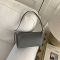 Détail rapproché de la texture cuir grainé du sac Boston gris de forme cylindrique - Gris