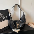 Detail of a large black glossy leather hobo bag with pleated texture and adjustable strap - Black