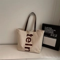 Cream canvas tote bag with brown leather straps and vertical letter print design - Light Khaki