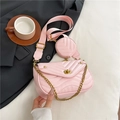 Pink quilted shoulder bag with chain detail and detachable coin purse on a black blazer - Pink