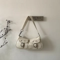 Detailed close-up of cream-white vintage underarm bag with double pockets and metal buckles - White