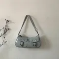 Detail of mint green leather shoulder bag featuring vintage buckles and dual front pockets - Blue