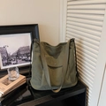 Detail of army green corduroy tote bag with wide strap and buttoned front pocket - Green