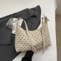 Vintage beige polka dot hobo bag with adjustable strap in a lifestyle setting - Off-white Without Pendant