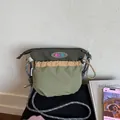 Detail of the multi-colored nylon crossbody bag with durable rope strap and logo patch - Green