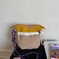 Detail of multi-color nylon crossbody bag with purple paracord strap and logo - Khaki
