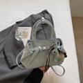 Detail of light blue leather handbag with pony charm and decorative buckle strap - Blue (With Pendant)