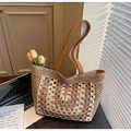 Close-up of handmade straw tote bag with crochet floral patterns and leather straps - Khaki