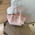 Pink pleated bucket bag with belt buckle and dual handles on a stylish cream sofa - Pink Without Pendant