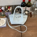 Chic light blue leather bucket bag with top handles and matching crossbody strap - Blue Without Charm
