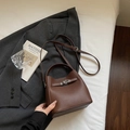 Brown lychee leather bucket bag with silver metal twist lock and adjustable shoulder strap - Brown
