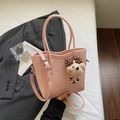 Pink bucket bag with lychee texture featuring a cute teddy bear charm and strap - With Charm / Pink