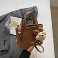 Brown litchi grain bucket bag with teddy bear pendant and adjustable shoulder strap - Brown with Pendant